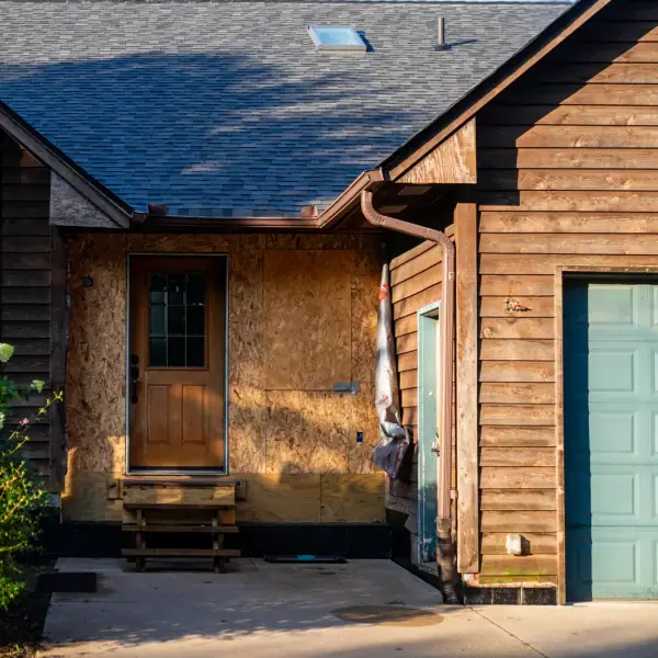 Entry area with siding removed to bare OSB sheathing during an exterior residing project.