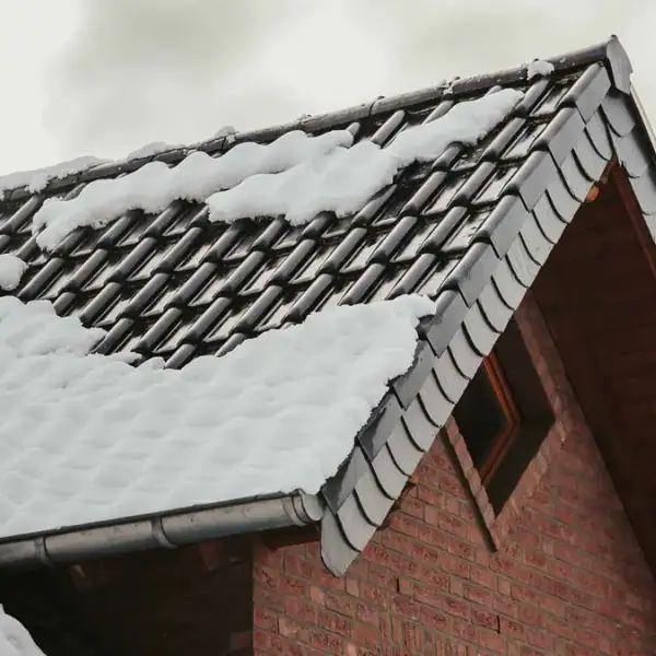 Roof snow removal in a Minnesota winter
